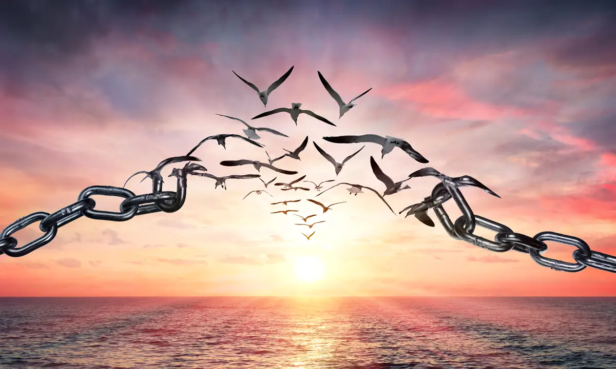 Dramatic digital image of a flock of birds flying across the ocean, through a thick metal chain and straight towards the viewer.