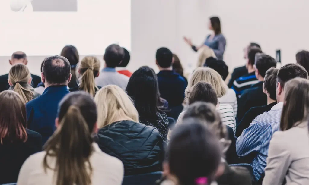 Photo of a woman giving a talk at a public debate.