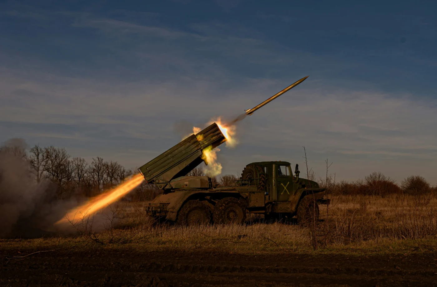 A military vehicle launching a missile into the air.