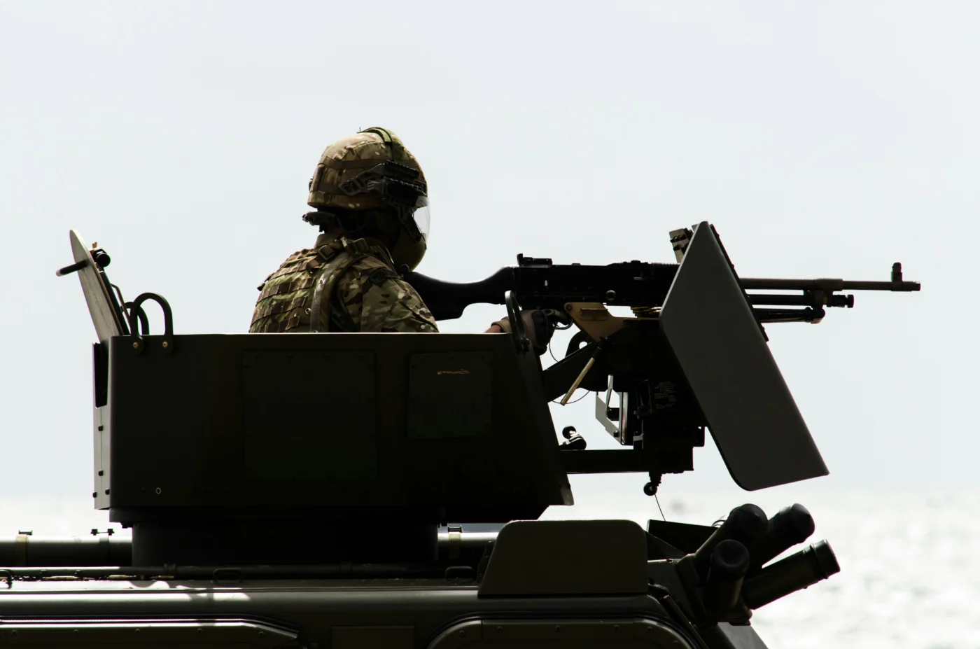 A British army solider in the turret of a battle tank.