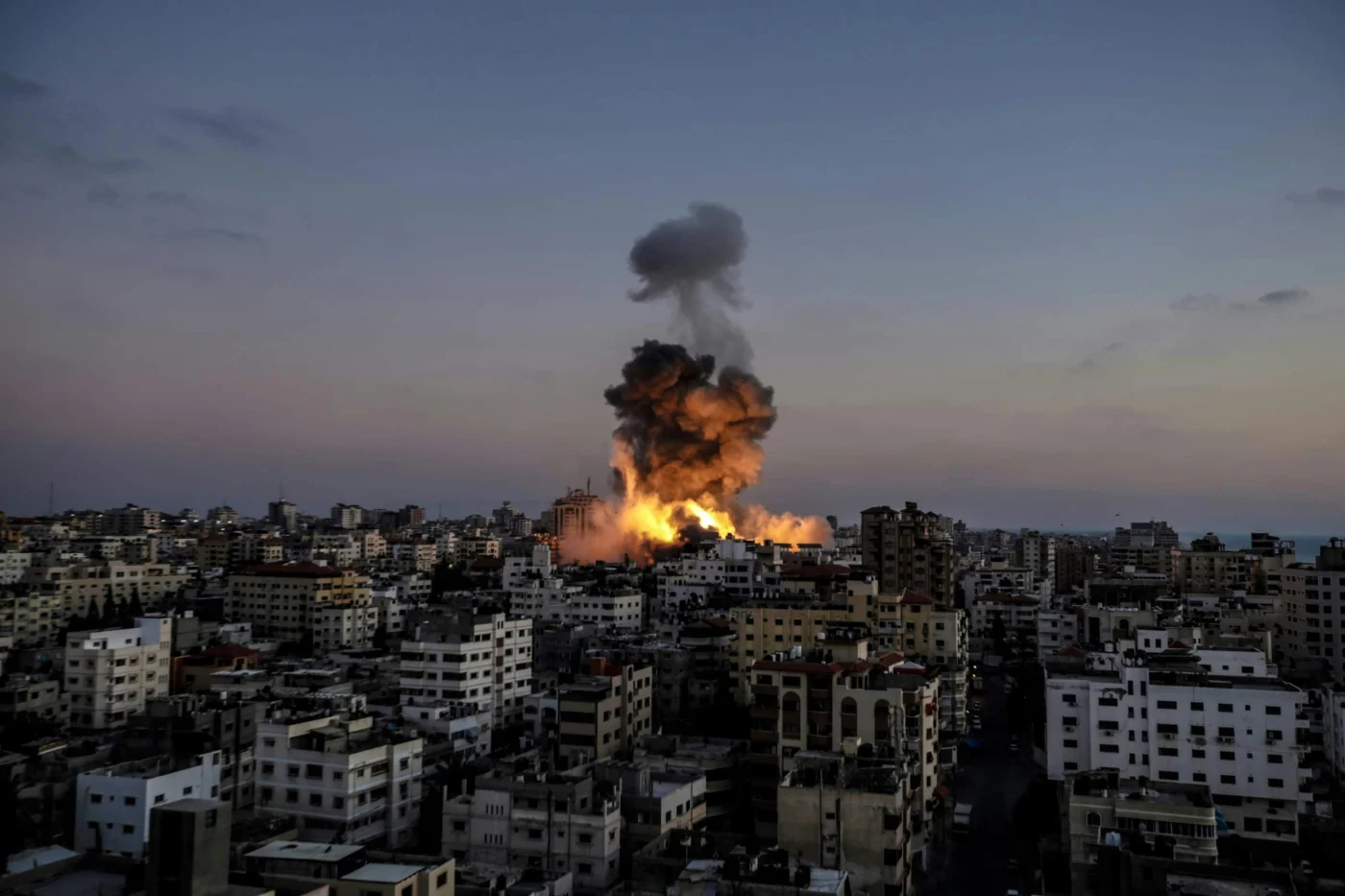 A huge explosion in a building in Gaza, Palestine, as a result of a bombing by Israeli warplanes.