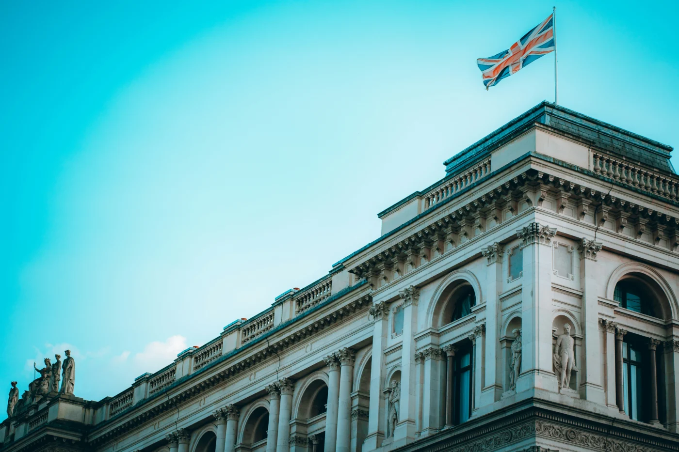 An ornate building with the UK's Union Jack flag flying on top of it.